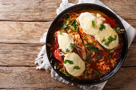 Italian chicken Sorrentino baked with eggplant, prosciutto, cheese and marinara sauce close-up on a plate. Horizontal top view from aboveの写真素材