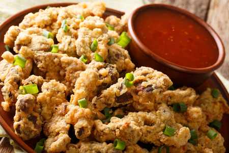 deep fried chicken gizzards in breadcrumbs with chili sauce close-up on a plate. horizontalの写真素材