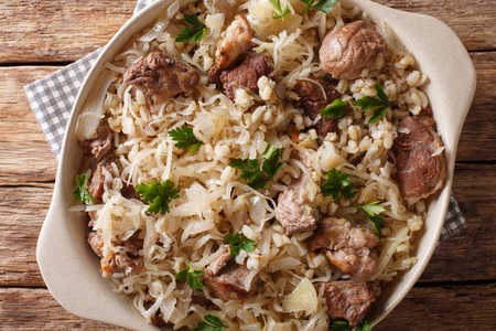 Rustic style Estonian mulgikapsas stewed pork with sauerkraut, onions and barley closeup in a dish on the table. horizontal top view from aboveの写真素材