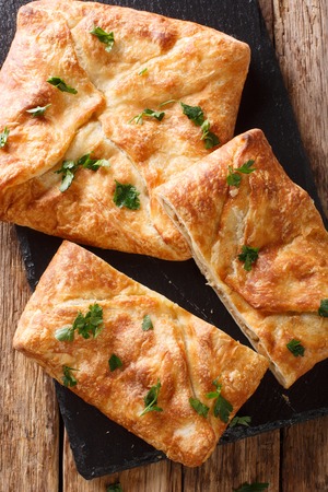 Khachapuri is a traditional Georgian dish of cheese-filled bread. The filling contains cheese sulguni, eggs and other ingredients Vertical top view from above
の写真素材