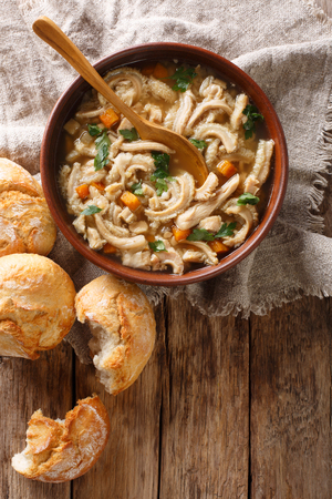 Polish stew flaki with vegetables close-up in a bowl on the table. Vertical top view from aboveの写真素材