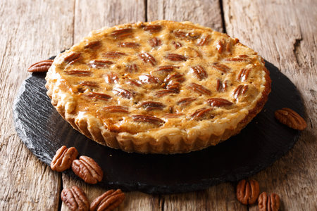 Tasty pecan cake with cinnamon and caramel close-up on a slate board on the table. horizontalの写真素材