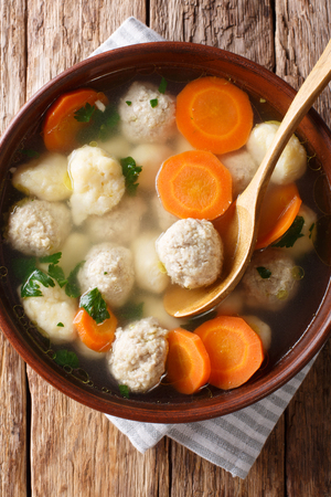 Delicious Danish soup with meat balls, dumplings and vegetables close-up in a bowl. Vertical top view above
の写真素材
