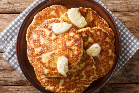 Delicious Sweet Griddle Cakes with butter close-up on a plate on the table. horizontal top view from...