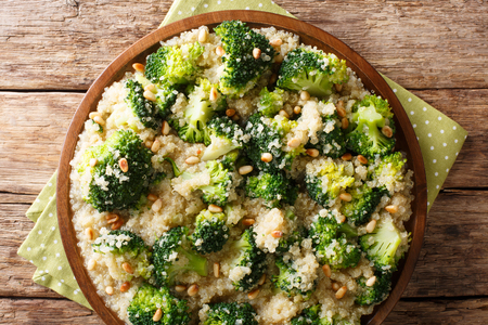 Homemade broccoli salad with quinoa and pine nuts closeup on a plate on the table. horizontal top view from aboveの写真素材