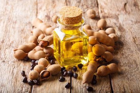 Tasty diet tamarind oil in a glass jar close-up on the table. horizontalの写真素材