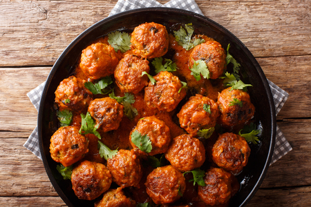 spicy chicken Indonesian Meatballs come complete in a creamy coconut curry sauce close-up on a plate on the table. horizontal top view from above
の写真素材