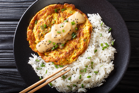 Chinese omelette Egg Foo Young served with rice close-up on a plate. Horizontal top view from aboveの写真素材