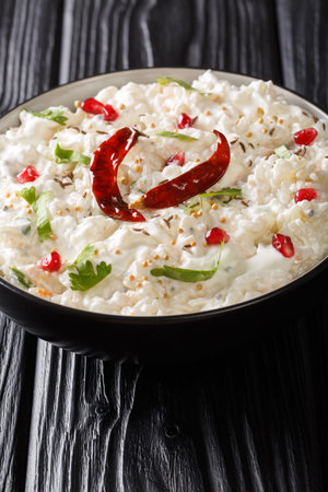 Curd Rice or Perugu Annam recipe is a perfect amalgamation of mild southern spices and sweet-tangy flavors of curd closeup in a plate on the table. Verticalの写真素材