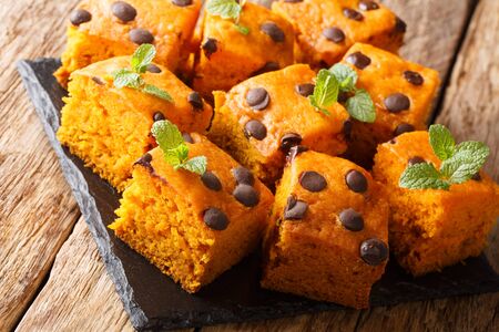Halloween pumpkin blondies with chocolate drops and mint closeup on a slate board on a table. horizontalの写真素材