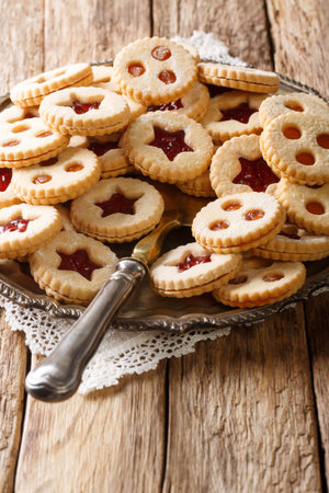 Christmas Linzer cookies stuffed with strawberry and apricot jam  close-up on the plate on the...