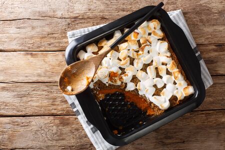 American sweet potato casserole with marshmallows close-up in a baking dish on the table. Horizontal top view from above
の写真素材