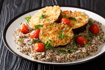 Healthy food baked eggplant served with boiled quinoa close-up on a plate on the table.の写真素材