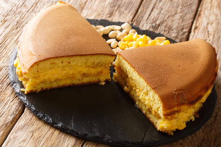 Apam balik is a Southeast Asian fluffy pancake with cream corn and peanuts close-up on the table....