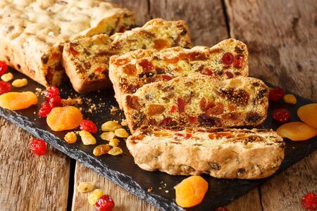 Traditional fruit cake with dried apricots berries raisins figs cherries closeup on a slate board on the table. horizontal
の写真素材