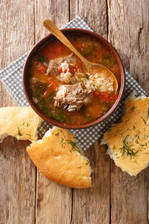Tasty traditional beef and rice kharcho soup with spices and vegetables served with pita bread...