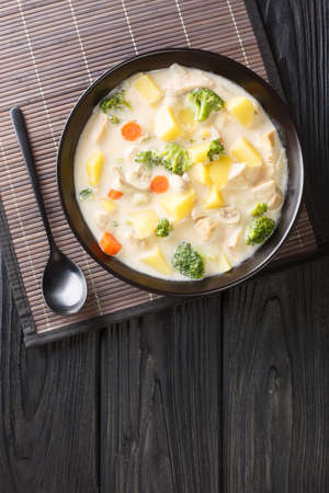 White Cream Stew is a classic Japanese style stew made with chicken, mushrooms, and vegetables close-up in a bowl on the table. Vertical top view from aboveの写真素材