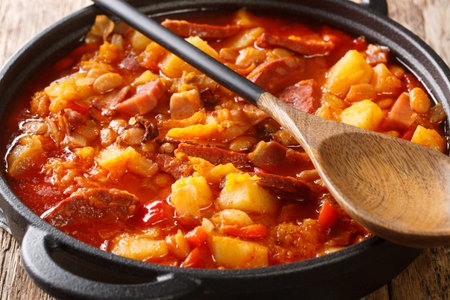 South American Locro stew of pumpkin, beans, corn and meat close-up in a pot on a table. horizontalの写真素材