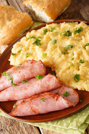 pease pudding is made from cooking yellow split peas served with fried ham closeup in the plate on...