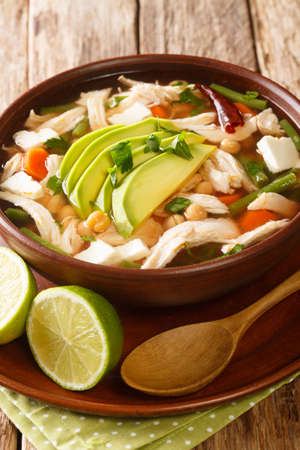 Caldo tlalpeno is a Mexican chicken soup with chickpeas and veggies close-up in a bowl on the table. horizontalの写真素材