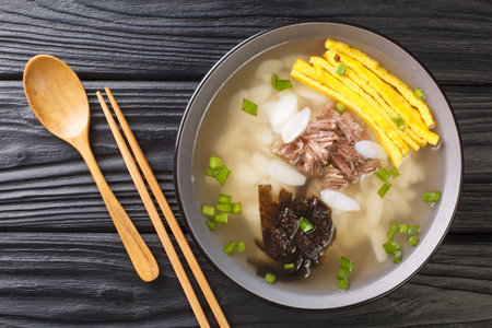 Tteokguk or sliced rice cake soup is a traditional Korean dish eaten during the celebration of the...