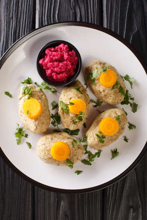 Jewish Gefilte Fish Recipe with Beet Horseradish closeup in the plate on the tble. Vertical top view from aboveの写真素材
