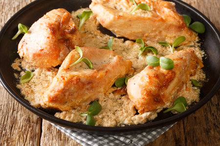 Classic Amish baked chicken breast with garlic and paprika close-up in a plate on the table. vertical top view from aboveの写真素材