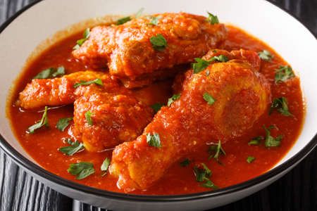 Spicy Tomato Chicken Ayam Masak Merah close-up in a bowl on the table. Horizontalの写真素材