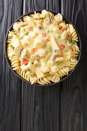 Classic Chicken a la King is rich and creamy and served over pasta close up in the plate on the...