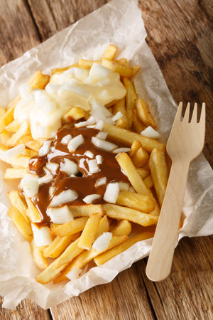 Patatje Oorlog Dutch War Fries topped with mayonnaise a thick Indonesian style peanut sauce, and raw...
