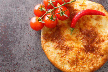 Georgian Mingrelian khachapuri topped with even more cheese close up in the table. Horizontal top view from aboveの写真素材