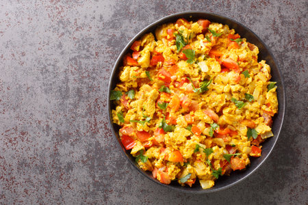 Classic Indian breakfast, egg Bhurji is a spicy mouth watering spin on scrambled eggs closeup in the...