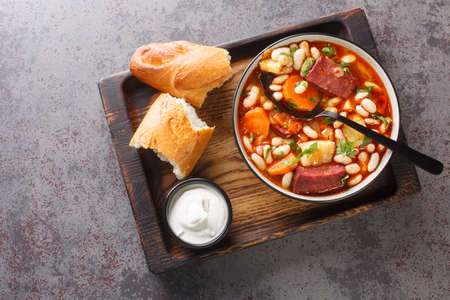 Hungarian goulash soup with beans, meat and vegetables close-up in a bowl on the table. horizontal top view from aboveの写真素材