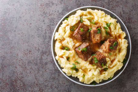 Greek Sofrito Traditional Beef Dish with mashed potatoes from Corfu with mashed potatoes closeup in the plate on the table. Horizontal top view from aboveの写真素材