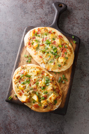 Dinnete is a traditional German dish originating from Baden-Wurttemberg is topped with sour cream,...