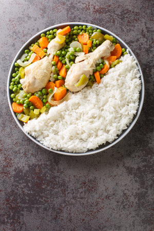 Pollo Arvejado or Peas and Carrots Chicken Stew is a classic Chilean comfort dish closeup in the plate on the table. Vertical top view from aboveの写真素材