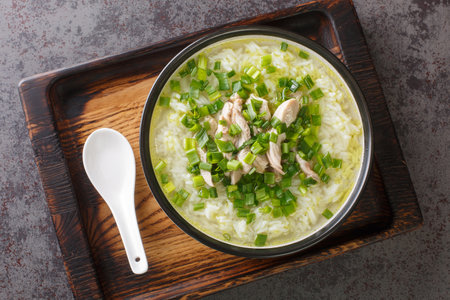 Dak Gomtang Korean Chicken Soup served with rice and green onion close-up in a bowl on the table. Horizontal top view from aboveの写真素材