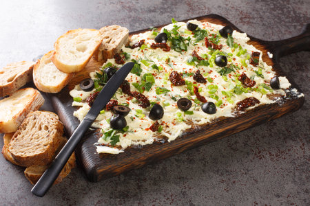 Appetizer Butter board, flavorful, food trend, spread, snack served with bread closeup on dark background. Horizontalの写真素材