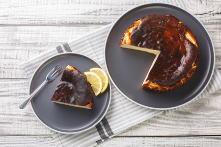 Restaurant style famous burnt San Sebastian cheesecake close-up on a plate on the table. Horizontal top view from aboveの写真素材