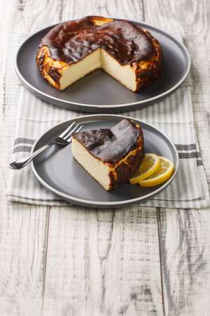 Freshly baked Spanish Burnt Basque Cheesecake closeup on the plate on the table. Verticalの写真素材
