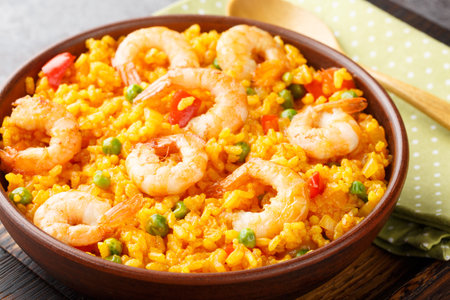 Yellow rice with shrimps arroz con camarones close-up in a bowl on the table. horizontalの写真素材