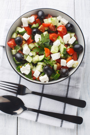 Coban Salatsi Turkish Shepherds Salad closeup on the bowl on the wooden table. Vertical top view from aboveの写真素材