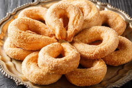Italian cookies Piedmontese Torcetti sprinkled with sugar close-up on a plate on the table....