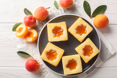 Tasty summer soft cookies Cuor di tenerezza with apricot jam close-up on a plate on the table. Horizontal top view from aboveの写真素材