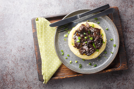 Tasty liver fried served with boiled potatoes close-up in a plate on the table. Horizontal top view from aboveの写真素材