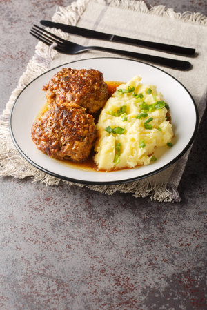 Hutspot met Gehaktballen Dutch Mashed Potatoes with Meatballs closeup on the plate on the table....