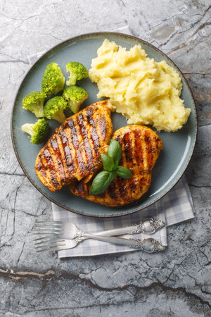 Healthy Homemade Grilled Chicken Breast and mashed potatoes with Broccoli closeup on the plate on the table. Vertical top view from aboveの写真素材