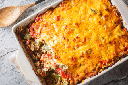 Casserole layers of ground beef, cheese, fresh vegetables and Jalapeno peppers baked closeup on the baking dish on the table. Horizontal top view from aboveの写真素材