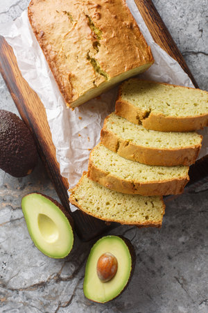 Sweet Avocado Quick Bread is the perfect breakfast, or snack closeup on the wooden board on the table. Vertical top view from aboveの写真素材