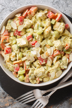 Pesto Chicken Salad with celery, onion, pepper and almond flakes closeup on the table. Vertical top view from aboveの写真素材